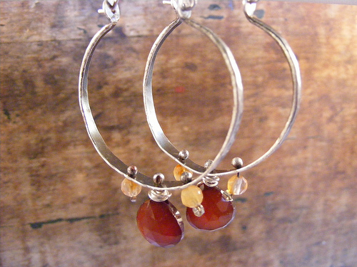 Carnelian briolettes and citrine rounds dangle from these sterling silver hammered hoops.
